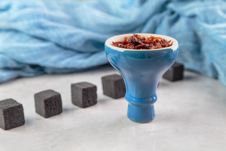 shisha with Apple flavor in glossy blue bowl, cooked for Smokingの写真素材