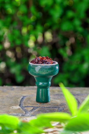shisha with Apple flavor in glossy green bowl, cooked for Smoking