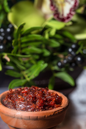 Hookah in a clay bowl for Smoking hookah on the background of greenery and orchidsの写真素材