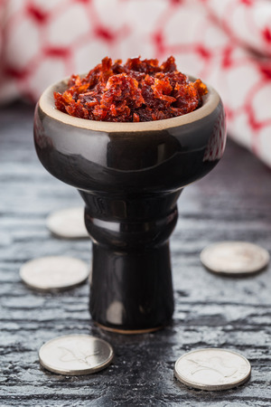 shisha with Apple flavor in a glossy black bowl, cooked for Smoking.の写真素材