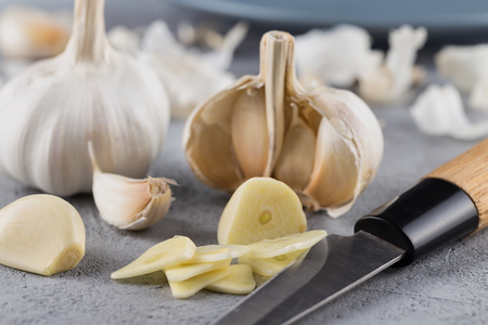 Garlic heads close-up on grey background. Condiment.の写真素材