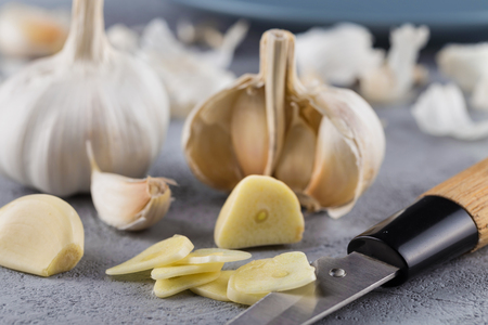 Garlic heads close-up on grey background. Condiment.の写真素材