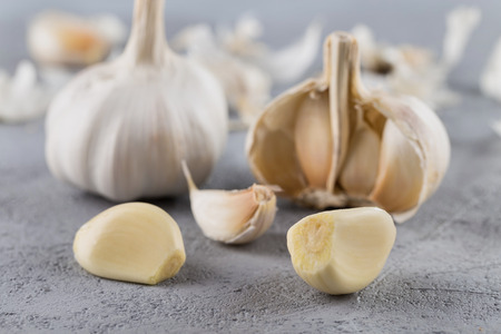 Garlic heads close-up on grey background. Condiment.の写真素材