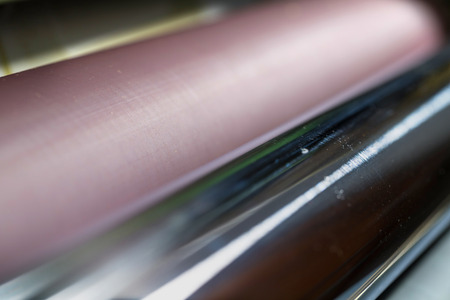 Rolling shafts in the paint of industrial printing machine. Offset printing.の写真素材
