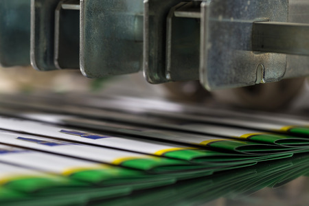 Folding machine industrial. Demonstration of the workflow. Equipment for color printing.