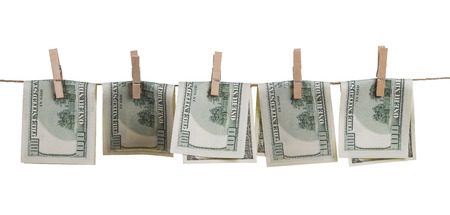 hundred dollar bills bent in half, attached with clothespins to a rope, isolated on white...