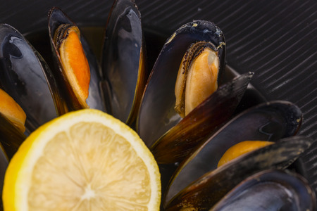 Mussels in wine with lemon. Seafood. Clams in the shells. Delicious snack for gourmands. Selective focusの写真素材
