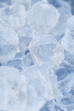 Frozen ice cubes for cocktails. Background with ice cubes. Selective focus