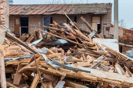 Construction debris from the dismantled building. Fragments of broken boards, tin and plaster. Horizontal.の写真素材