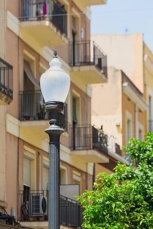 Antique street lamp on the background of old buildings. Tarragona, Spain. Selective focus.の写真素材