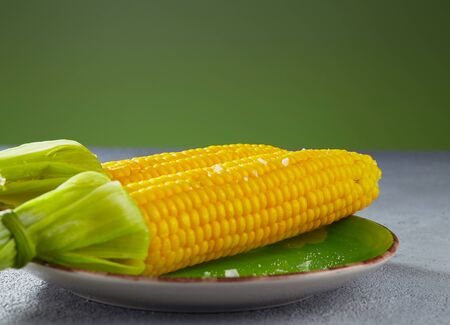 Boiled corn on a plate in the kitchen. Selective focus.の写真素材