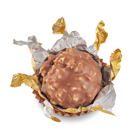 Beautiful candy in gold wrapper ball shape in paper skirt isolated on white with shadows. Full sharpness across the surface.の写真素材