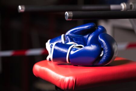 Pair Boxing gloves blue colour on a chair outside the ring.の写真素材