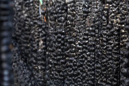 charred planks of the walls of the building after the fire.