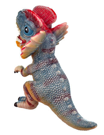 Toy dinosaur of bright coloring with an open mouth and an unfolded collar with spikes, stands on its hind legs, highlighted on a white background. Rear view.の写真素材