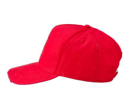 Red textile baseball cap with a visor, isolated on a snow-white background. Side view.の写真素材