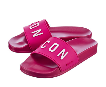 Beautiful pair of bright fuchsia colors Dsquared 2 rubber beach sandals, with white ICON lettering isolated on a white background. Comfortable shoes for beach holidays. Belarus, Minsk, 28.02.2023.のeditorial素材