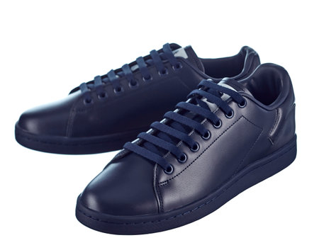 Fashionable modern sneakers made of blue soft leather, lace-up, isolated on a white background.の写真素材