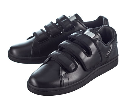 Fashionable modern sneakers made of black soft leather, velcro, isolated on a white background.の写真素材