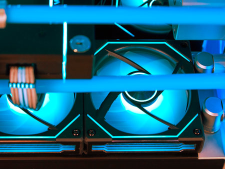 Close-up view from inside a fragment of a water cooling system in a high-performance modern computer with a beautiful blue LED backlight. Soft focus.の写真素材