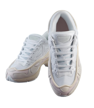 Beautiful pair of mens white sneakers of modern design, on a sports polyurethane sole, isolated on a white background.の写真素材