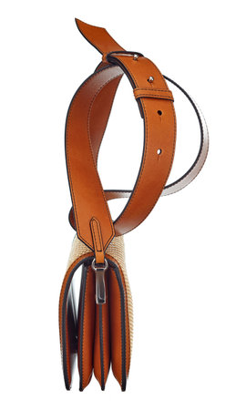 Elegant womens purse bag made of red rawhide, on a massive leather strap, isolated on a white background. Side view. Expensive womens accessories.の写真素材