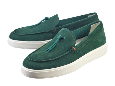 Fashionable modern sneakers made of emerald green suede, without lacing, with a shock-absorbing sole, isolated on a white background.の写真素材