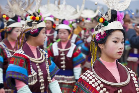 Guizhou Province, China - January, 2012: Black Miao girls dancing at festival, Kaili, Guizhou Province, Chinaのeditorial素材
