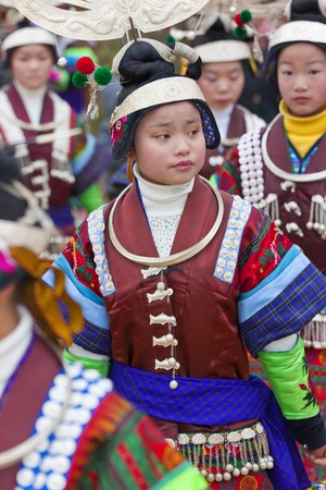 Guizhou Province, China - January, 2012: Black Miao girls dancing at festival, Kaili, Guizhou Province, Chinaのeditorial素材