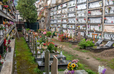 View of the famous hillside cemetery with graves and crypts, decorated with bouquets of flowers, on the Amalfi coast,Campania, Italyのeditorial素材