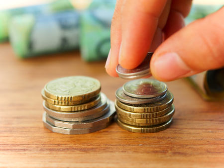 Woman stacked up Australia coins for saving money conceptの写真素材