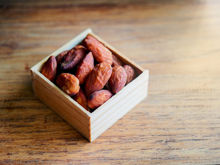 Roasted almond on wooden table.の写真素材
