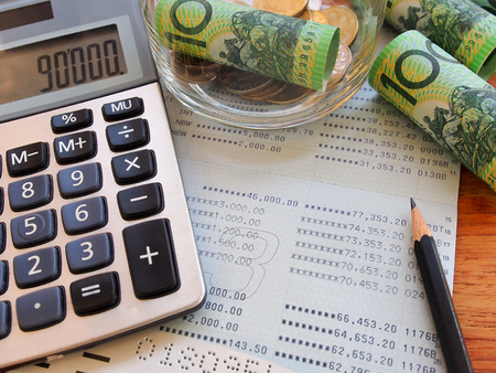 Dollar australia bank note,coins,account book and calculator in  saving money conceptの写真素材