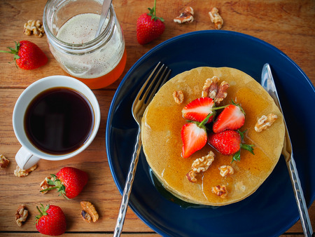 American pancakes with honey,walnut  and strawberry for healthy breakfast concept.の写真素材