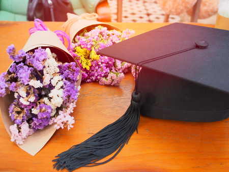 Graduation cap with flower bouquets in congratulations dayの写真素材
