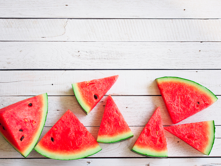 Sliced watermelon flay lay on wooden white in summer beach concept with copy spaceの写真素材
