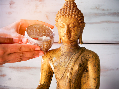 Pouring water onto Buddha statue in Songkran festival traditional in summer season in Thailandの写真素材