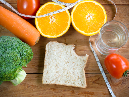 Whole wheat bread and vegetables on table for diet and healthy food concept.の写真素材
