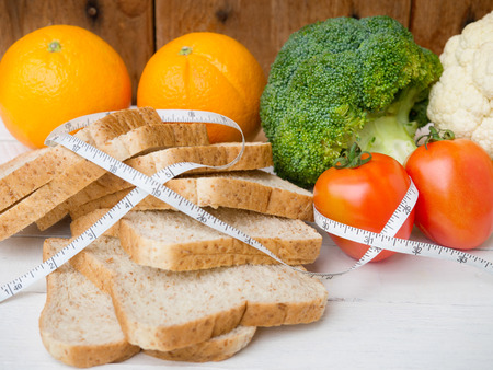 Vegetable and whole wheat bread with measuring tape for diet food concept.の写真素材