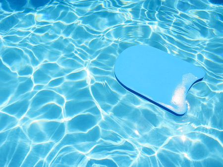 Kick board floating in swimming pool for summer vacation concept with copy space.の写真素材