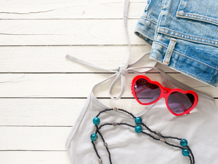 summer holiday  clothes,Beach accessories on white wooden background with copy space for vacation concept.の写真素材