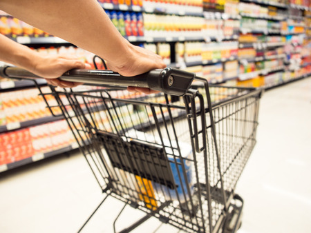 Customer with shopping cart in supermarket.の写真素材