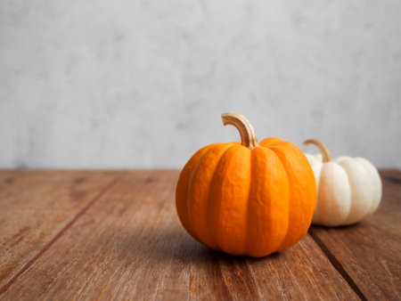 Decorative pumpkins on a rustic wooden table with copy space for autumn concept.の写真素材