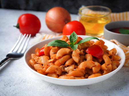 Macaroni pasta with tomato sauce on white wooden tableの写真素材