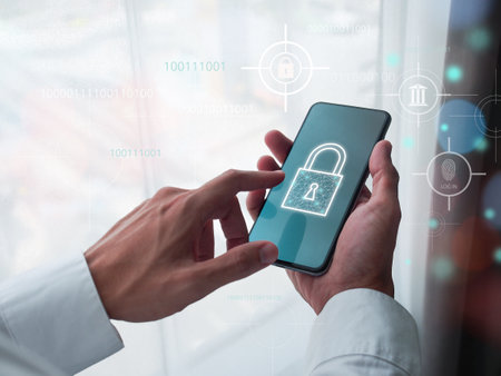 Cyber security, Data privacy, Cybercrime, Data protection, Verify identity. Businessman holding smartphone in hand with lock key icon on screen.の写真素材