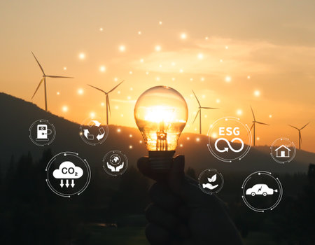 Renewable energy, clean technology concept. Light Bulb and ecosystem icons on wind turbine and nature backgroundの写真素材