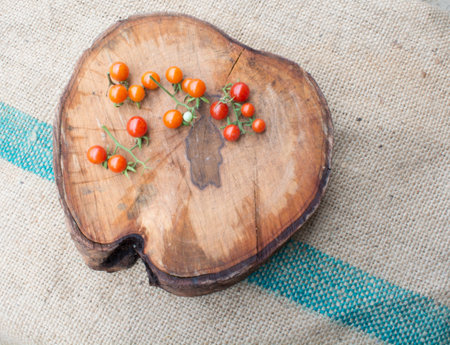 Gac and mini tometos on the old cutting wood closeup shotの写真素材