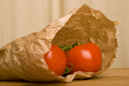 tomato in brown paper bagの写真素材