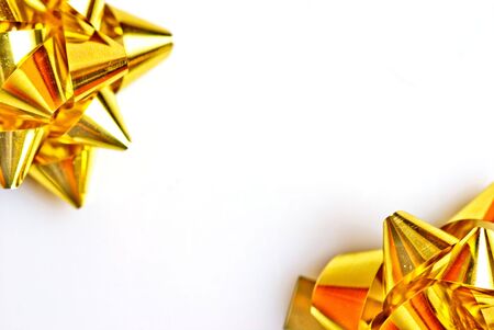 two gold bows on a white backgroundの写真素材