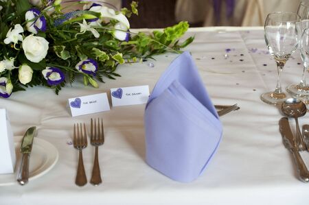table setting at wedding breakfast with bride and groom tagsの写真素材